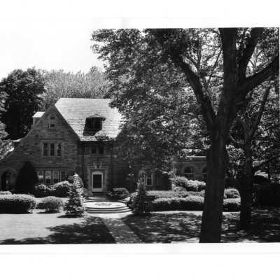View of front of Regis Hall from Saint Thomas Hall in summer.