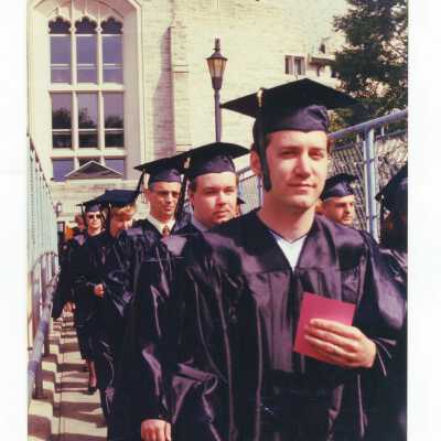 Masters degree students processing across McShain pedestrian bridge during 1999 graduation/commencement.