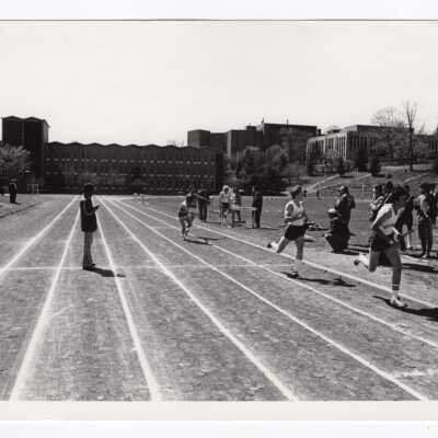 Men's track meet with Bellarmine, Science Center,and Drexel Library in background.