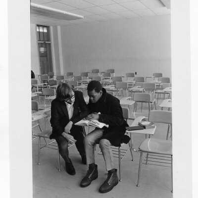 Student tutoring child at Rhoads Public School (?) as part of community service/outreach project. (Peace and Human Development program?)
