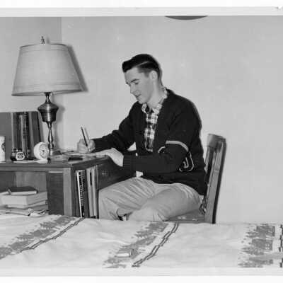 Student resident of Quirk Hall studying on dormitory room.