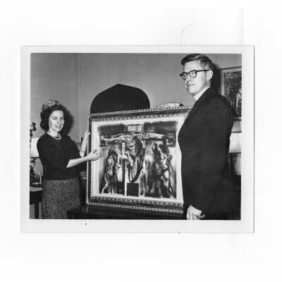 Jerome Coll, S.J. accepts on behalf of Saint Joseph's College a work of art from Victoria Donohue of the Friends of Art Association.