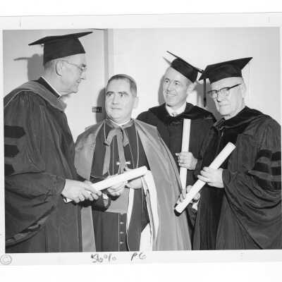 William F. Maloney, S.J., with three honorary degree recipients, Bishop Gerald V. McDevitt, Raymond E. Trainer, and Daniel J. O'Conor, at 1963 graduation/commencement.