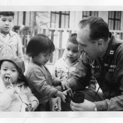 U.S. soldier with Vietnamese orphans, Vietnam Orphanage Project.