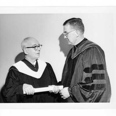William F. Maloney, S.J., with honorary degree recipient, J. Gordon Wright, during October 1962 graduation/commencement.