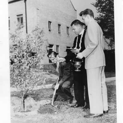 Students planting tree near Field House during Junior Week activities with Edward G. Jacklin, S.J. President, c. 1952.