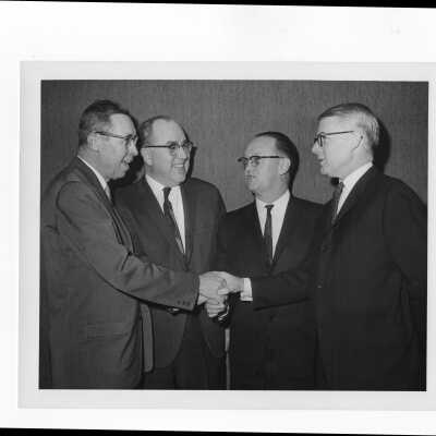 Dr. Daniel Hilferty (?) and other alumni association officers at a planning committee meeting, January 18, 1964.
