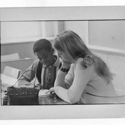 Woman student tutoring child at Rhoads Public School as part of community service/outreach project. (Part of Peace and Human Development Program?)