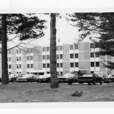 View of parking lot with cars in front of Sourin Residence Center.
