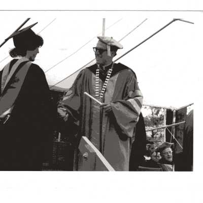 Several views of graduation/commencement ceremony, c. 1981, one with Donald I. MacLean, S.J. awarding diploma to student and other views of graduates and guests in audience.