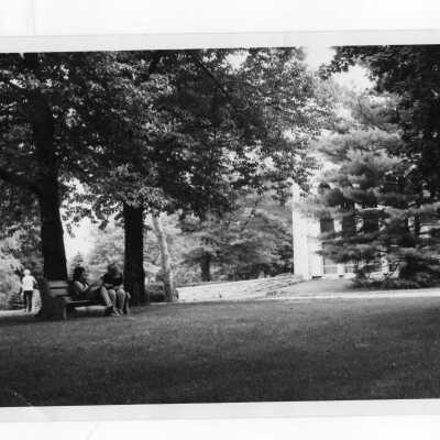 Two women students sitting on park bench near Drexel Library.