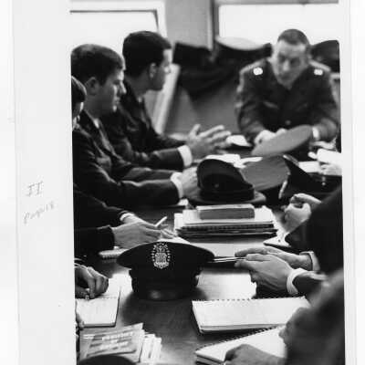 Air Force ROTC students sitting at a table during meeting.