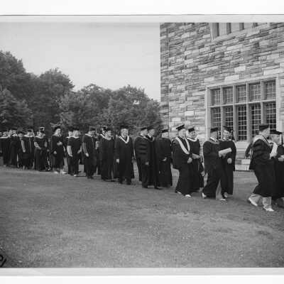 Faculty processing toward Barbelin quadrangle during 1948 graduation/commencement ceremony.