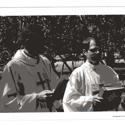Donald I. MacLean, S.J., standing with another priest during Baccalaureate service, 1980 graduation/commencement.