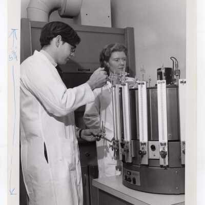 Two biology students using refrigerated Warburg apparatus for study of cell physiology, March 1968.