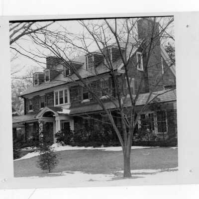 View of front of Saint Albert's Hall with snow on ground.