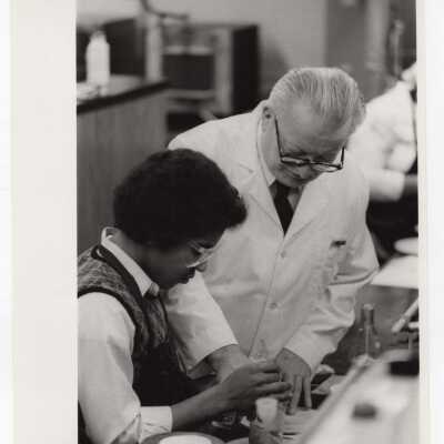 George Beichl, SJC chemistry professor, working with a high school student in laboratory as part of Chemistry Department's Science Motivation Program, c. 1972.