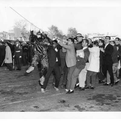 Students and Hawk mascot pulling down Cardboard College also known as Barbelin Annex.