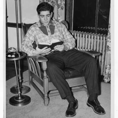 Student residents of Quirk Hall reading in living room.