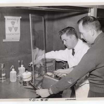 Chemistry professor, Joseph Feighan, with graduate student, Robert Weiner in science laboratory, February 1958.