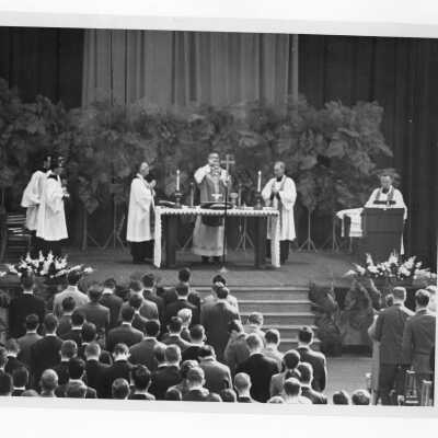 William F. Maloney, S.J., and others during Mass of the Holy Spirit in Field House, c. 1962.
