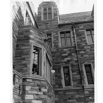 Exterior view of portion of Barbelin building showing windows and gargoyle.
