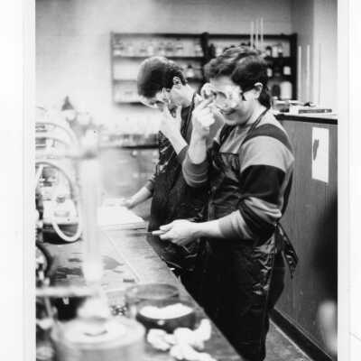 Two male students working on experiment in science laboratory.