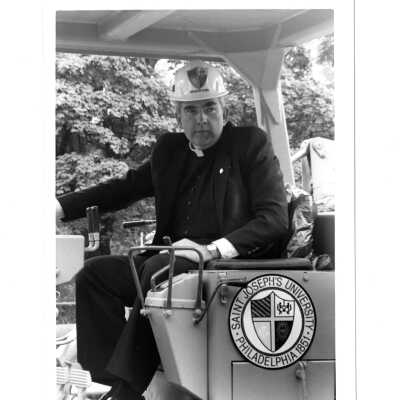 Nicholas S. Rashford, S.J. on Caterpillar bulldozer at McShain Hall groundbreaking.