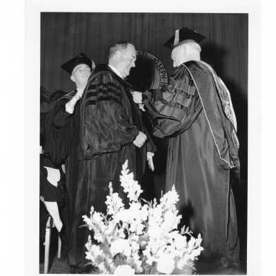 J. Joseph Bluett, S.J., conferring honorary degree to Augustus Long during 1961 graduation/commencement.