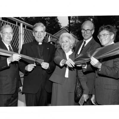 Ribbon cutting for pedestrian bridge to McShain Hall with Nicholas S. Rashford, S.J., Mary McShain, Michael Morris and others.