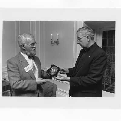 Denis Lucey of Cork College in Ireland visiting campus. Denis Lucey presents President Nicholas Rashford with decorative plaque of University College, Cork.
