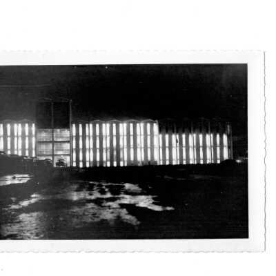 Exterior view of Bellarmine with lights on inside building.