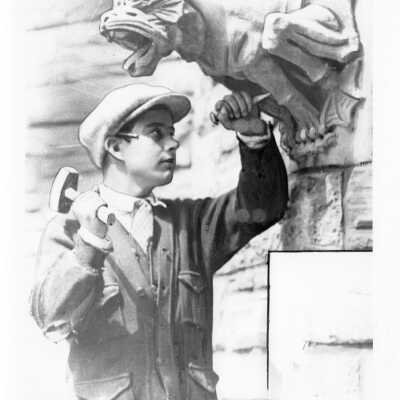 Anthony Agunsday, foreman of the stone masons, finishing gargoyle on Barbelin building near end of construction.