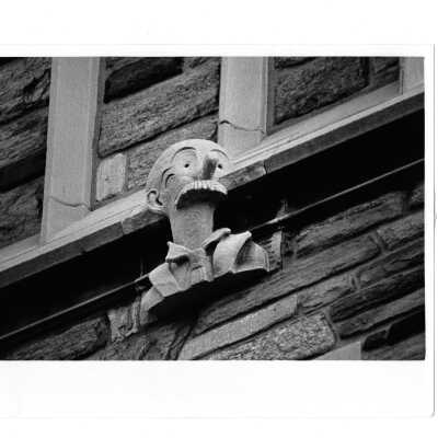 Gargoyle on exterior of Barbelin in likeness of Andy Gump, cartoon bungler of 1920s.