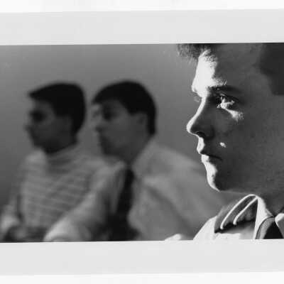 Three male students listening to lecture.