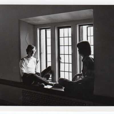 Interior view of two students sitting in window alcove in Barbelin hallway.