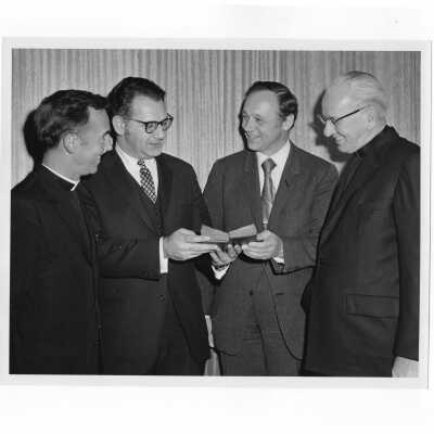 Rabbi Marc Tanenbaum, Cardinal John Krol, Terrence Toland, S.J., and and another individual examining ancient book during Third Institute on Catholic -Jewish Relations, March 2, 1971.