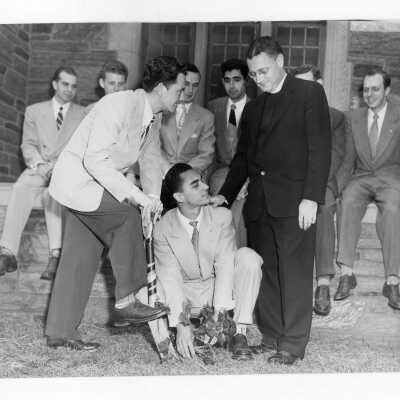 Students, including John Daly and Joseph Kraft, and Edward G. Jacklin, S.J. President at ivy planting ceremony during Junior Week.