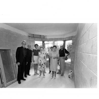 Mary McShain, Michael J. Smith, S.J. and others visiting construction site of McShain Hall.