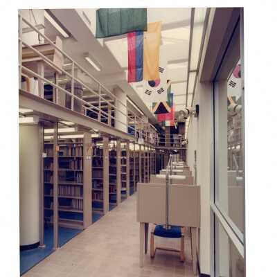 View of upper level stack, study desks, and flags in Drexel Library.