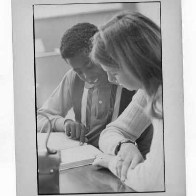 Woman student tutoring child at Rhoads Public School as part of community service/outreach project. (Part of Peace and Human Development Program?)