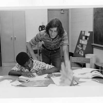 Student tutoring child at Rhoads Public School as part of community service/outreach project? (Part of Peace and Human Development Program?)