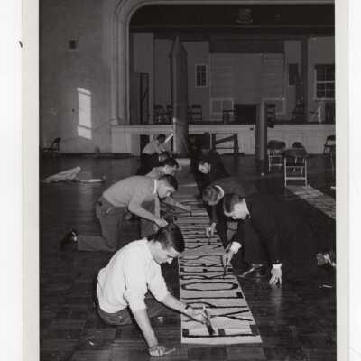 Men's Basketball, students making banner for game.