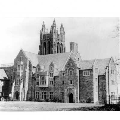 Exterior view of front of Barbelin building with workman in front.