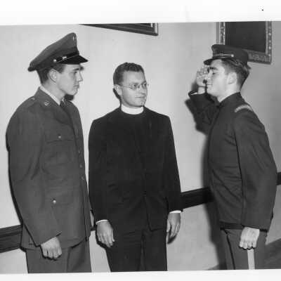 Edward G. Jacklin, S.J. with Tom Duffy in SJC cadet corps uniform (loaned from Breen family) and Bill Berry in ROTC uniform during centennial celebration event held October 21-28, 1951. Event featured exhibit of historical memorabilia.