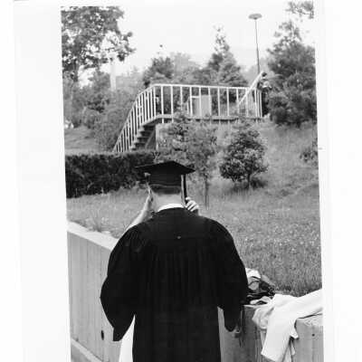 Individual having cap straightened outside Bellarmine Hall during 1968 graduation/commencement.