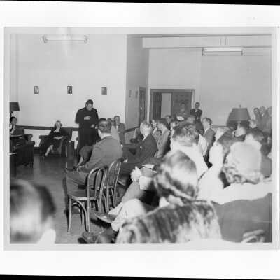 Edward G. Jacklin, S.J., addressing alumni group and their wives, c. 1953.