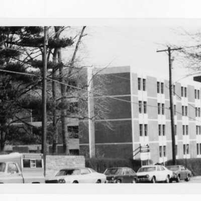 View of cars parked on Cardinal Avenue with Sourin Residence Center in background.