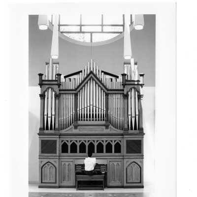 View of man playing pipe organ in Chapel of Saint Joseph.