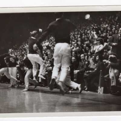 Men cheerleaders at basketball game.